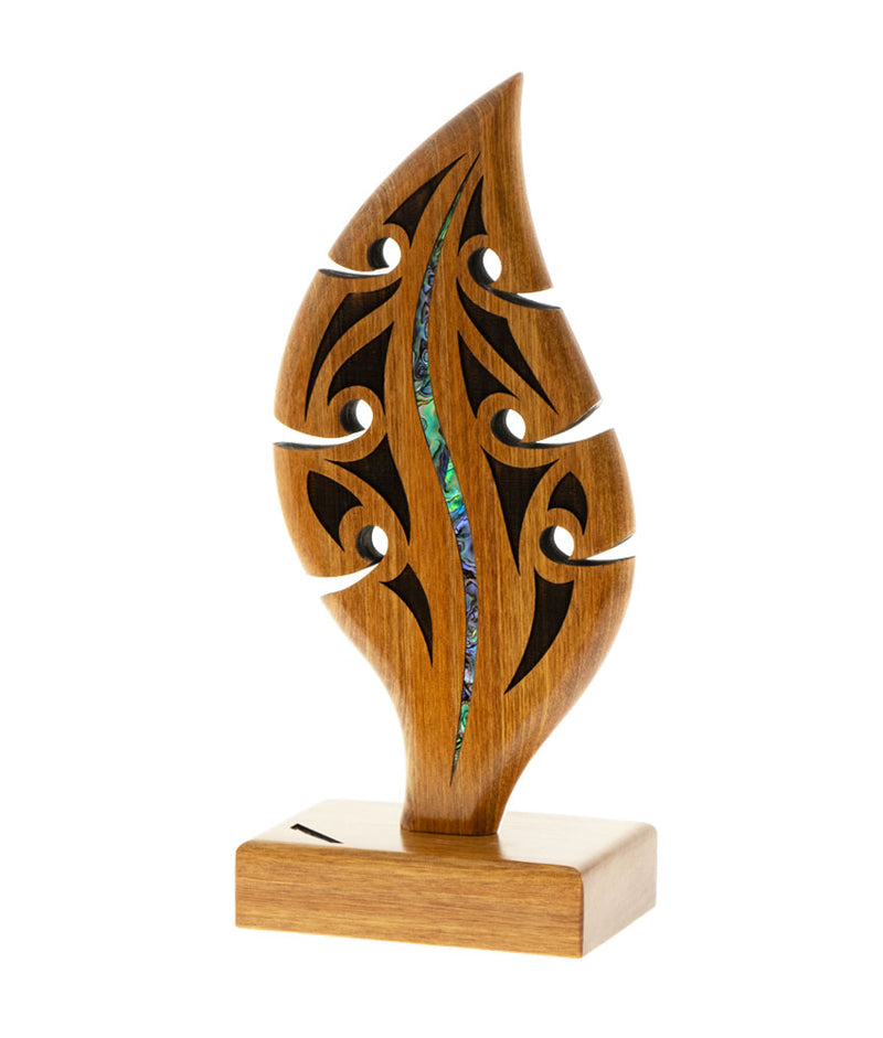 Wooden hoe/paddle award with intricate carvings and inlayed Pāua shell